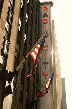 NEW YORK, USA - OCTOBER 13, 2022: usa flags on building of Radio City music hall
