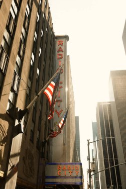 NEW YORK, USA - OCTOBER 13, 2022: usa flags on Radio City music hall building in Manhattan