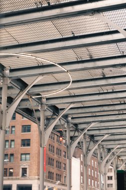 metal roof construction near blurred building on city street in New York City clipart