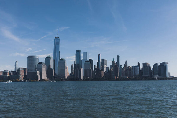 Hudson river harbor with Manhattan skyscrapers in New York City under blue sky