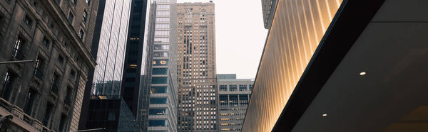 modern buildings and illuminated entrance in Manhattan district of New York City, banner