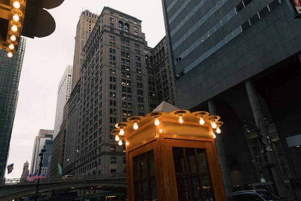 vintage phone booth with lamps on evening street in New York City