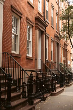 brick building with metal railings and Halloween skeletons on street of New York City