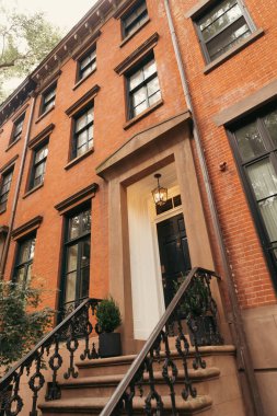 low angle view of brick house with lantern above entrance in Brooklyn Heights district of New York City clipart
