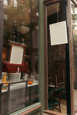 Empty signboards on showcase of shop on street in New York City