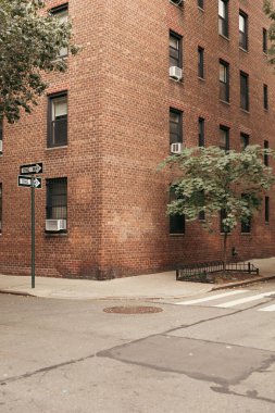 Pointers and trees near brisk building on street in New York City