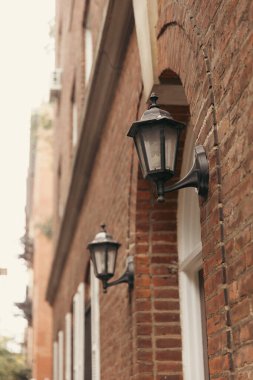 Lanterns on brick facade of building in New York City