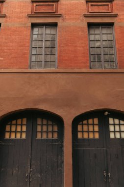 Wooden doors on facade of brick building on street in New York City