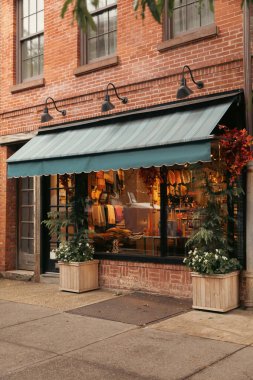 Showcase of shop on facade of building on street in New York City clipart