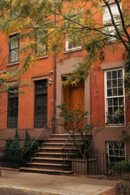 Steps near entrance of house on street in New York City clipart