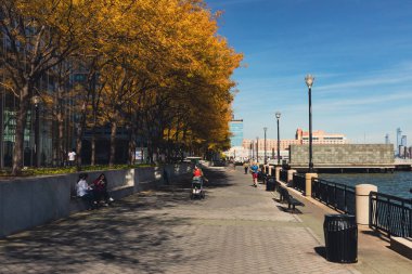 NEW YORK, USA - OCTOBER 11, 2022: Hudson river waterfront walkway during autumn 