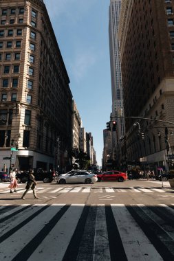 NEW YORK, USA - OCTOBER 11, 2022: Crosswalk on road near buildings at daytime 