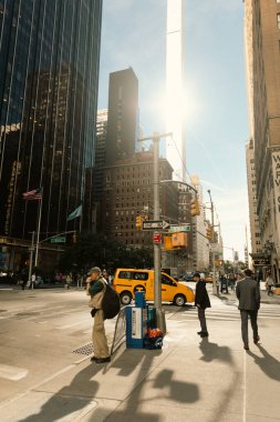 NEW YORK, USA - OCTOBER 11, 2022: People on sidewalk near road on urban street in Manhattan 