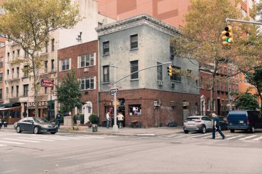 NEW YORK, USA - OCTOBER 11, 2022: Urban street with road and building on street in Manhattan 