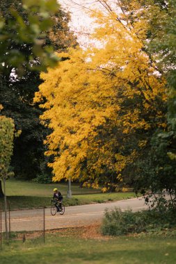 NEW YORK, USA - OCTOBER 11, 2022: Man cycling on street during autumn 