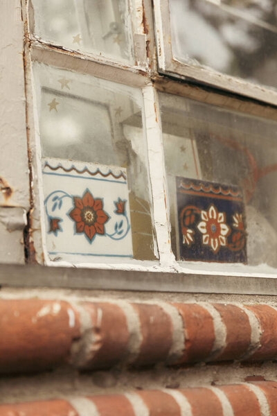 old window and tiles with floral pattern in Brooklyn Heights district of New York City