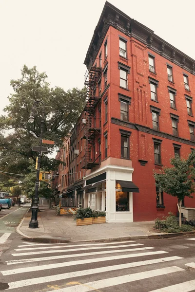 Corner of brick building on urban street in New York City at daytime 
