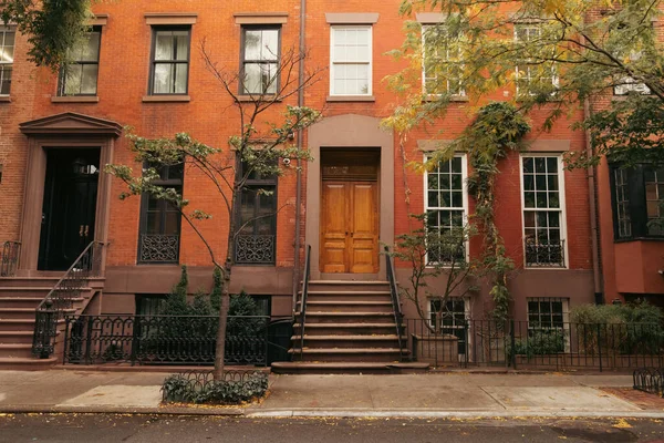Facade of building with steps and doors on urban street in brooklyn heights in New York City