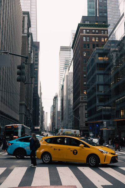 NEW YORK, USA - OCTOBER 11, 2022: Taxi car on crosswalk on urban street in Manhattan 