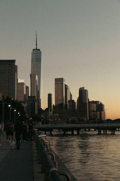 NEW YORK, USA - OCTOBER 11, 2022: Buildings of world trade center and Hudson river in evening 