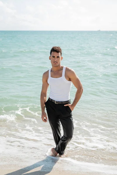 stock image handsome muscular young Cuban man standing in ocean water in Miami South Beach, Florida