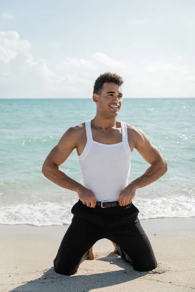 stock image Carefree and muscular young cuban man standing in Miami South Beach, Florida