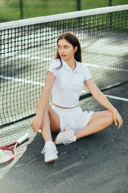 female tennis player resting after game, young woman with brunette long hair sitting in white outfit and shoes near racket, ball and tennis net, blurred background, Miami, iconic city, tennis court  clipart