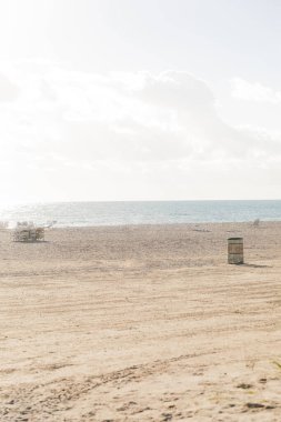 Kumlu bir plaja park edilmiş karavan, açık bir gökyüzünün altında deniz kenarında hasat için hazır..