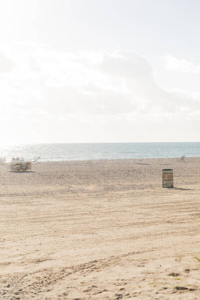 trailer parked on a sandy beach, ready for a seaside harvest under a clear sky.