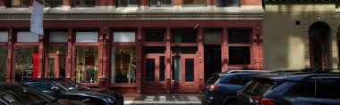 vintage building and cars moving on roadway of downtown district in new york city, banner clipart