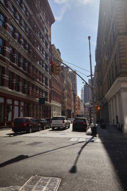 heavy traffic in rush hour on roadway of downtown district in new york city, fall streetscape clipart