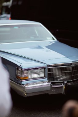 luxury vintage car parked on roadway in new york city, urban environment, blurred foreground clipart