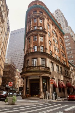 NEW YORK, USA - NOVEMBER 26, 2022: Stone building with balustrade on balcony in downtown of new york city, vintage architecture clipart