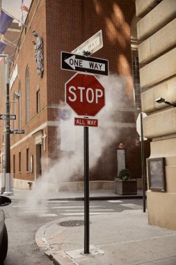 road signs near steam and vintage buildings in downtown of new york city, metropolis environment clipart