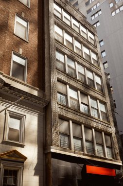 modern and vintage buildings on urban street in new york city, creative architectural symbiosis clipart