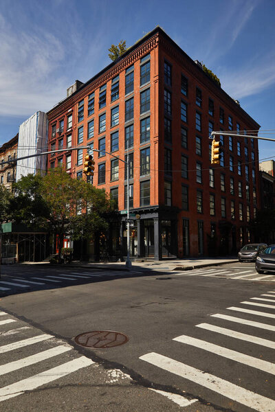 cars moving on crossroad with traffic lights in downtown of new york city, autumnal urban scene
