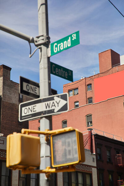 buildings and traffic signs showing directions on crossroad in new york city, urban signage