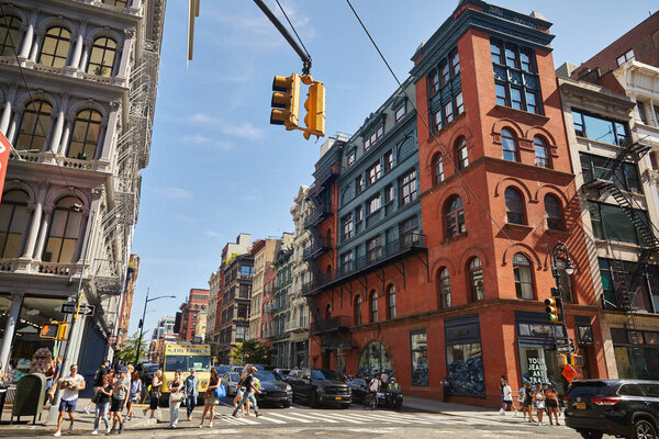 NEW YORK, USA - NOVEMBER 26, 2022: pedestrians crossing roadway intersection on busy avenue