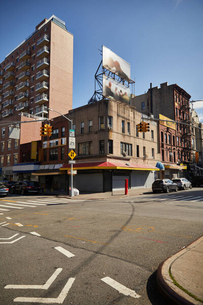 crossroad with traffic lights on wide avenue in Asian town, new york city streetscape