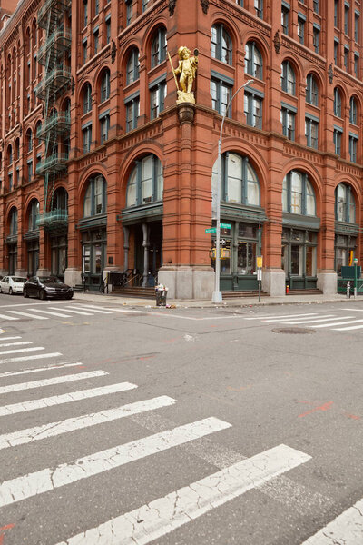 NEW YORK, USA - NOVEMBER 26, 2022: Crosswalk near iconic puck building on crosswalk in manhattan district, landmark of new york city