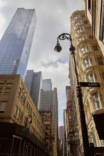 Low angle view of decorated lantern near vintage buildings and modern skyscrapers in new york city