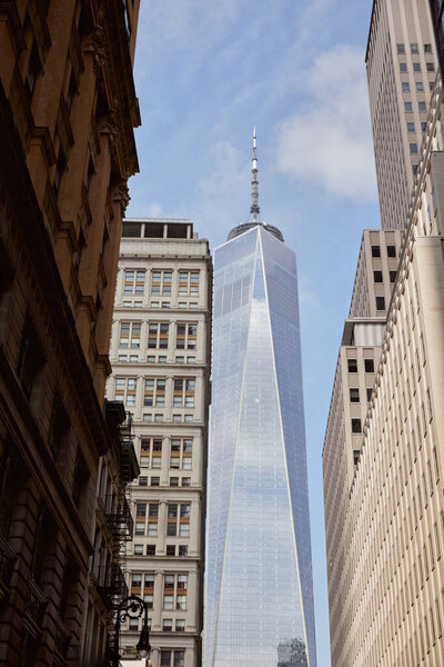NEW YORK, USA - NOVEMBER 26, 2022: One world trade center near modern and vintage building in new york city, urban architecture