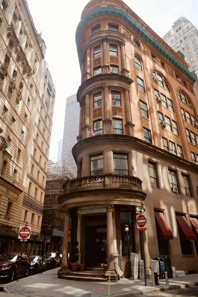 vintage building with stone balustrade on balcony in downtown of new york city, urban architecture
