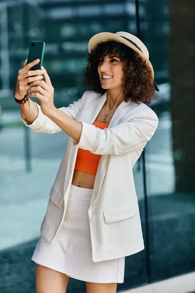 stock image A woman takes a selfie in front of a modern building in Europe.