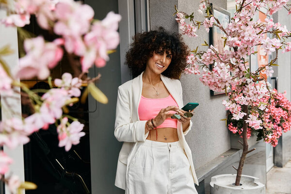 A woman in stylish attire enjoys a trip through a European city, surrounded by blooming cherry blossoms.