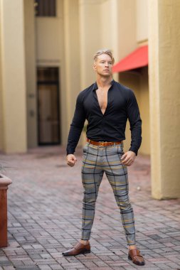 Yakışıklı sarışın bir adam şık giyinmiş. Orlando, Florida 'da bir cadde boyunca yürüyor..