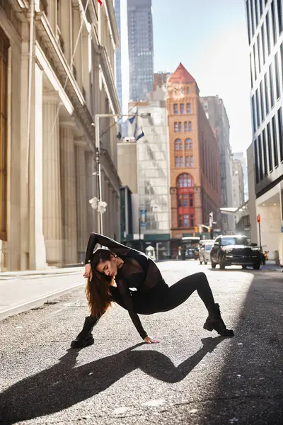 stock image A young woman dances on a New York City street, her movements echoing the citys energy.
