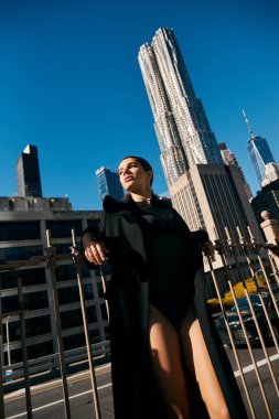 A young woman dances in the streets of New York City, with skyscrapers towering above. clipart