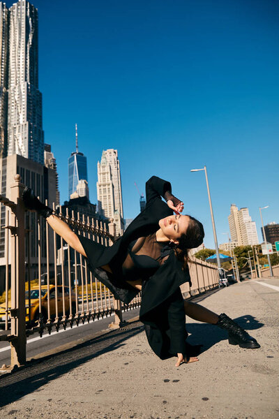 Young woman dances in NYC, showcasing artistry in urban landscape.