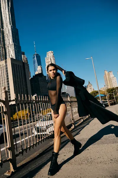 stock image A young woman dances on the streets of New York City, showcasing her grace and confidence.